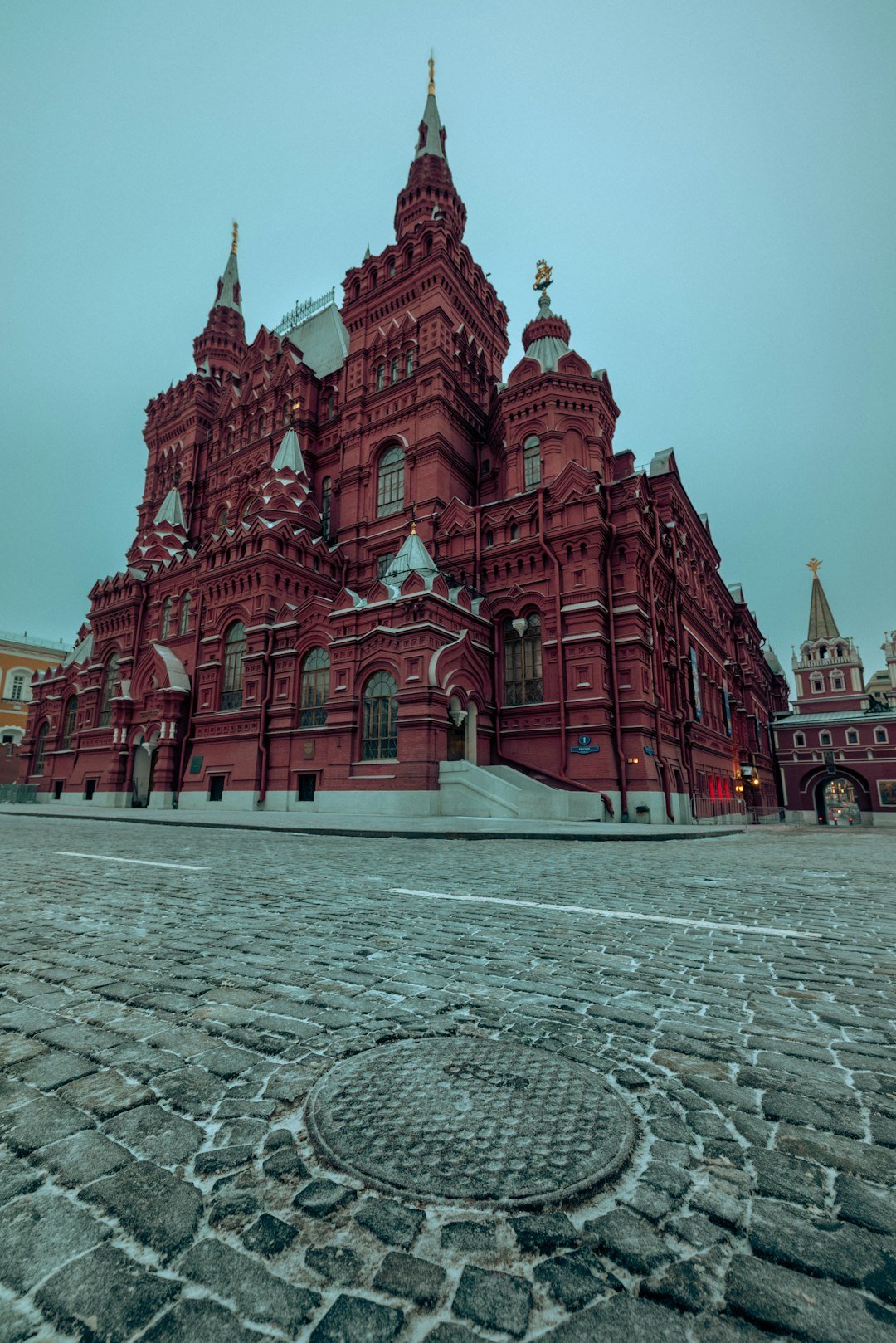 a-large-red-building-with-a-clock-tower-on-top-of-it-thbx9kdndka